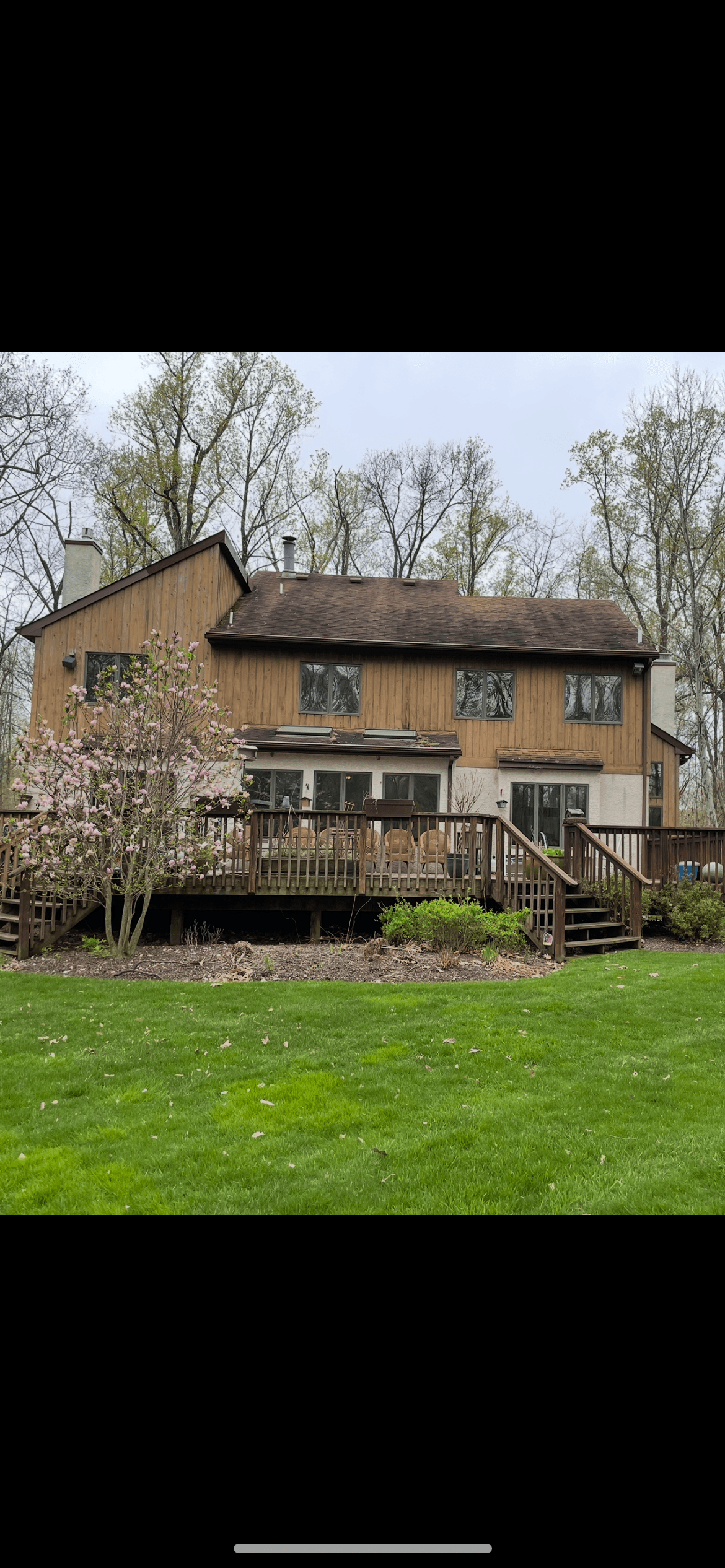 Before image of historic Doylestown home exterior showing peeling paint, dated trim, and failing flashings.