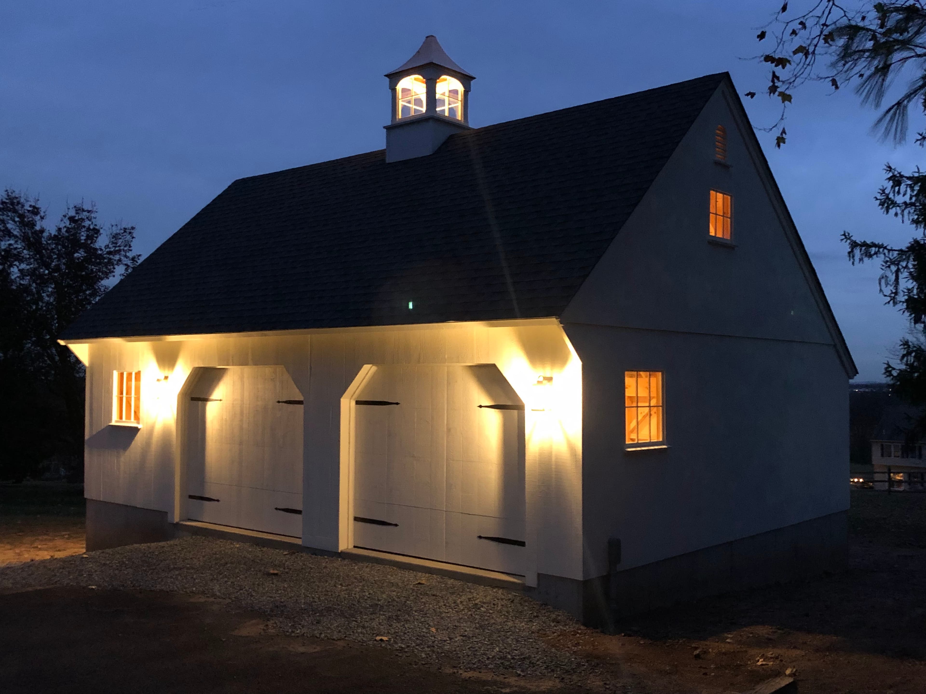 A detached garage built by Red Bridge Construction in Bucks County, PA, lit at dusk