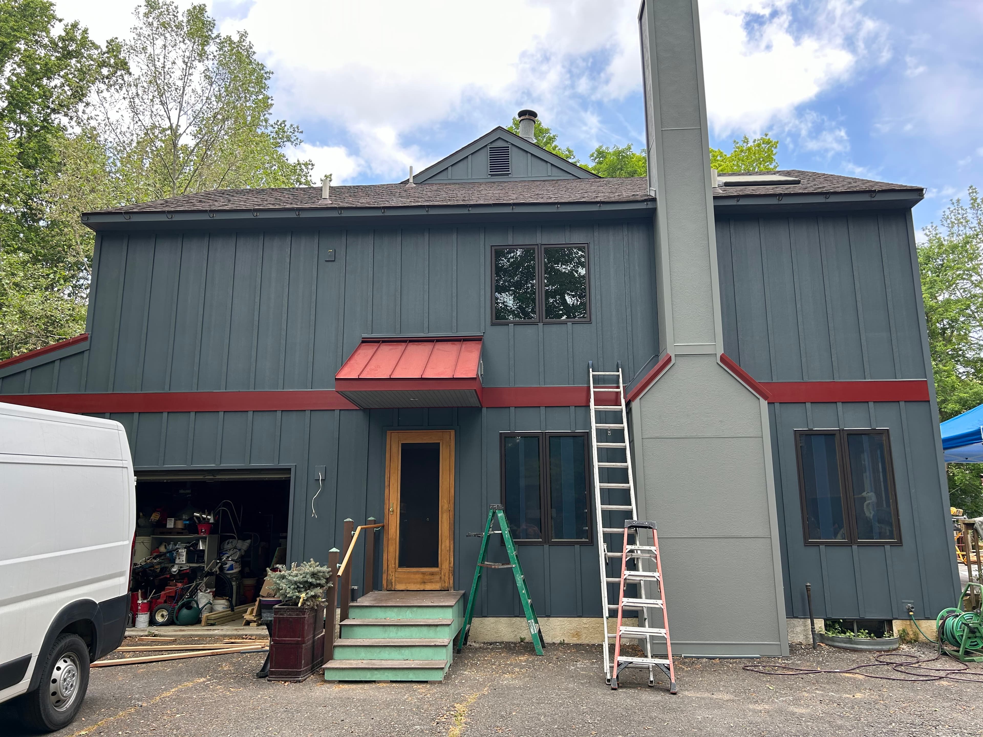 Restored facade angle showing period-accurate paint scheme and seamless aluminum gutters.